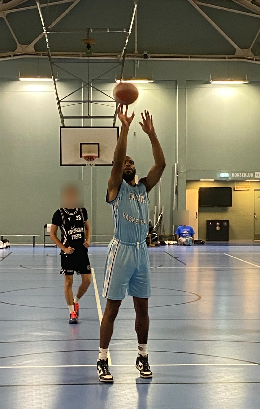 Talata Basketball player at the free throw line in the club's home uniform